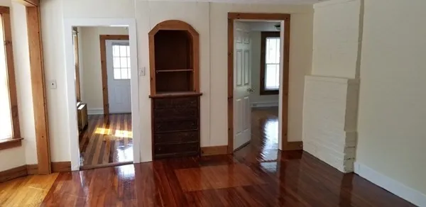 wooden floor in an empty room with a window