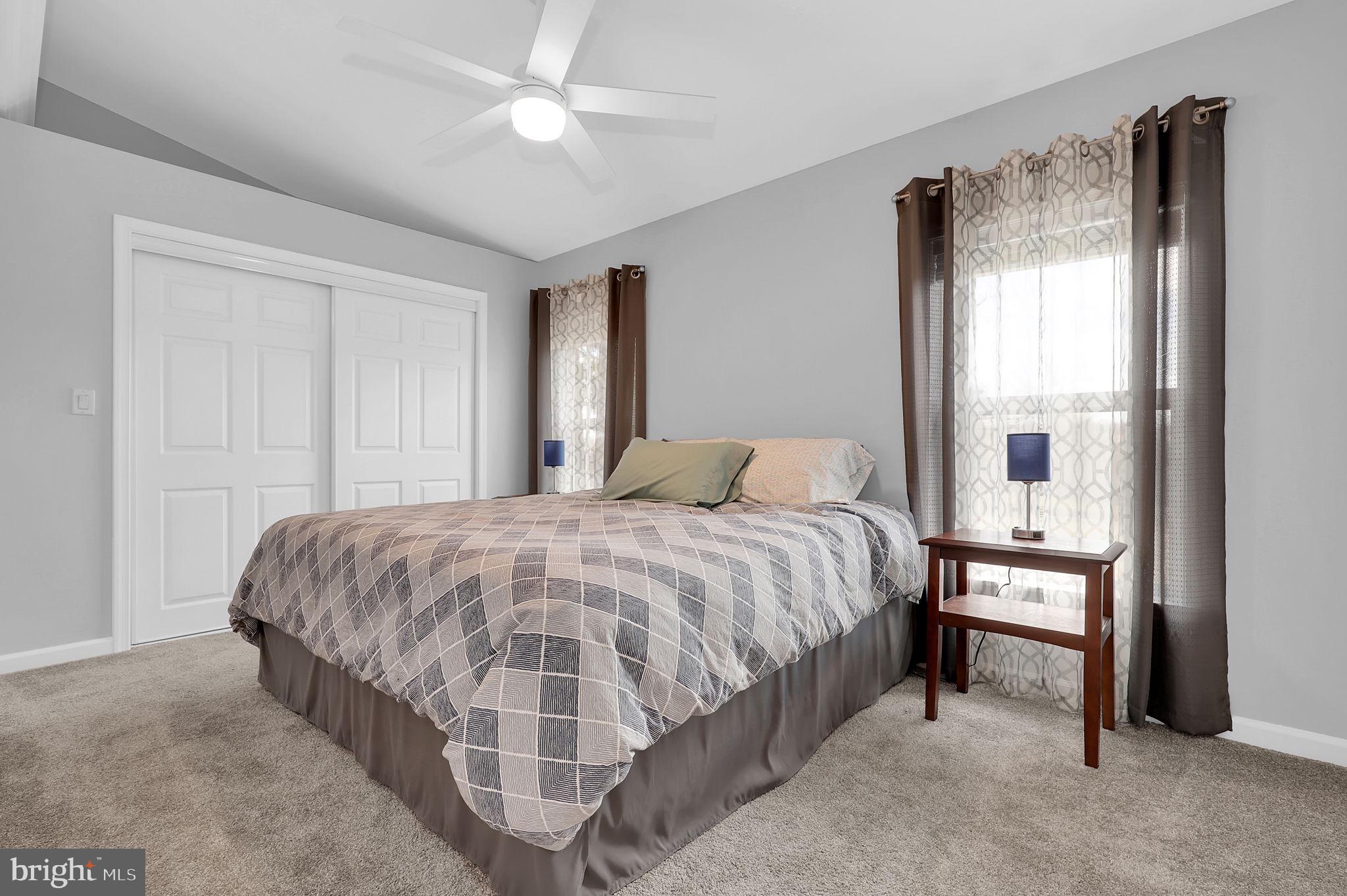 14336 Shirley Bohn Road Mount Airy, MD 21771 - Photo 22 of 56 a spacious bedroom with a bed and a chandelier