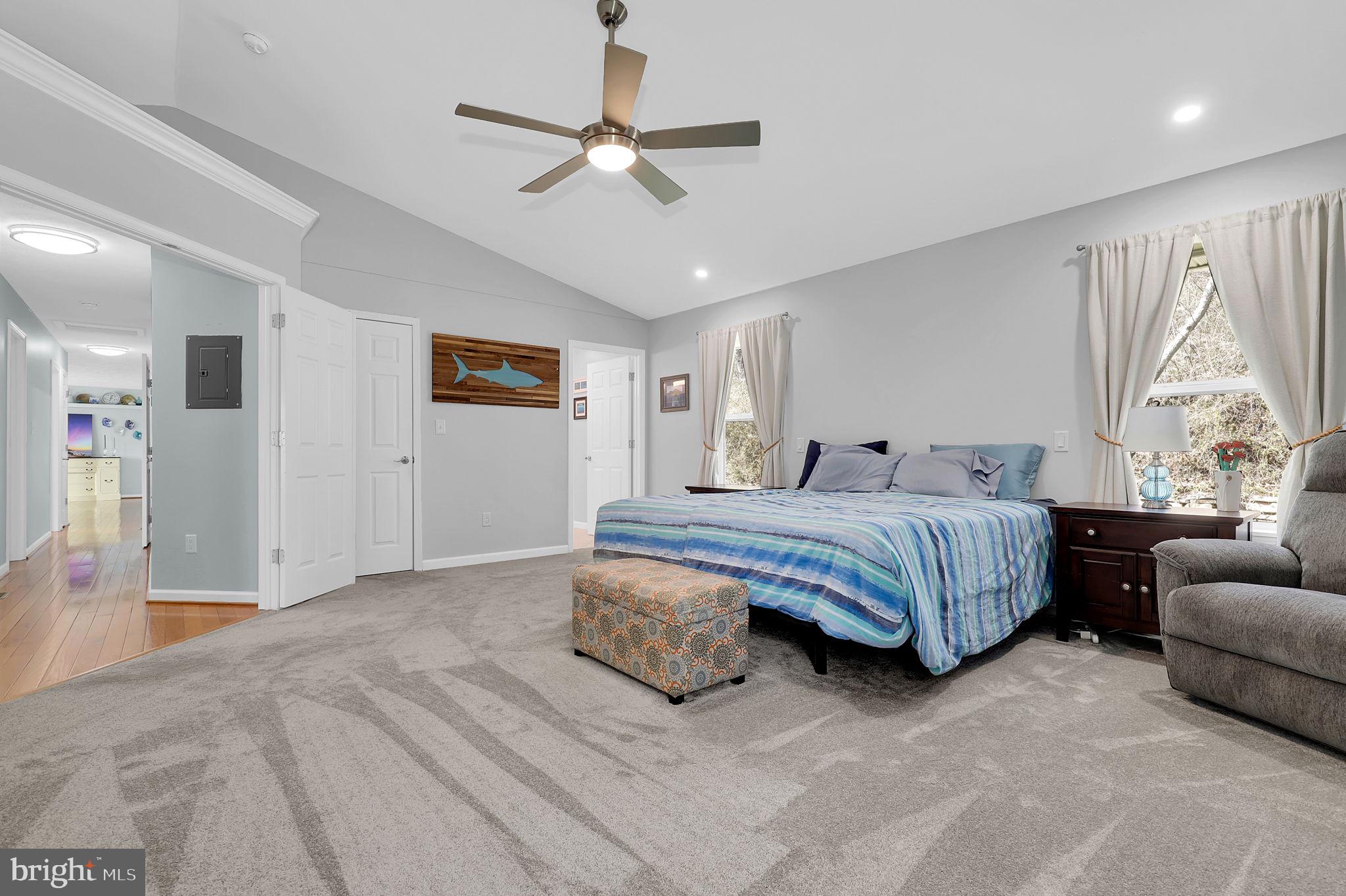 14336 Shirley Bohn Road Mount Airy, MD 21771 - Photo 24 of 56 a bedroom with a bed couch chandelier and a window