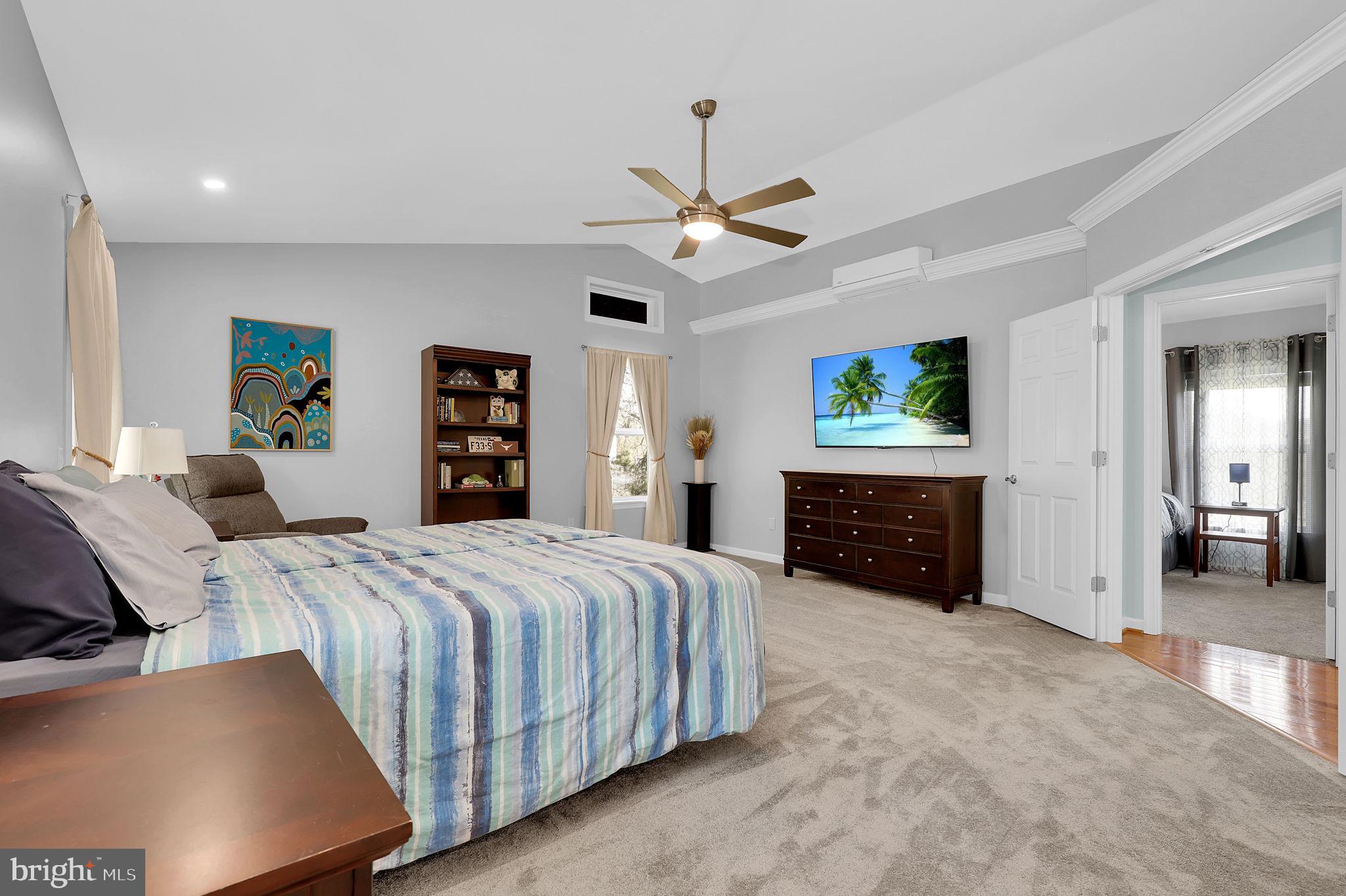 14336 Shirley Bohn Road Mount Airy, MD 21771 - Photo 25 of 56 a bedroom with a large bed and a flat tv screen