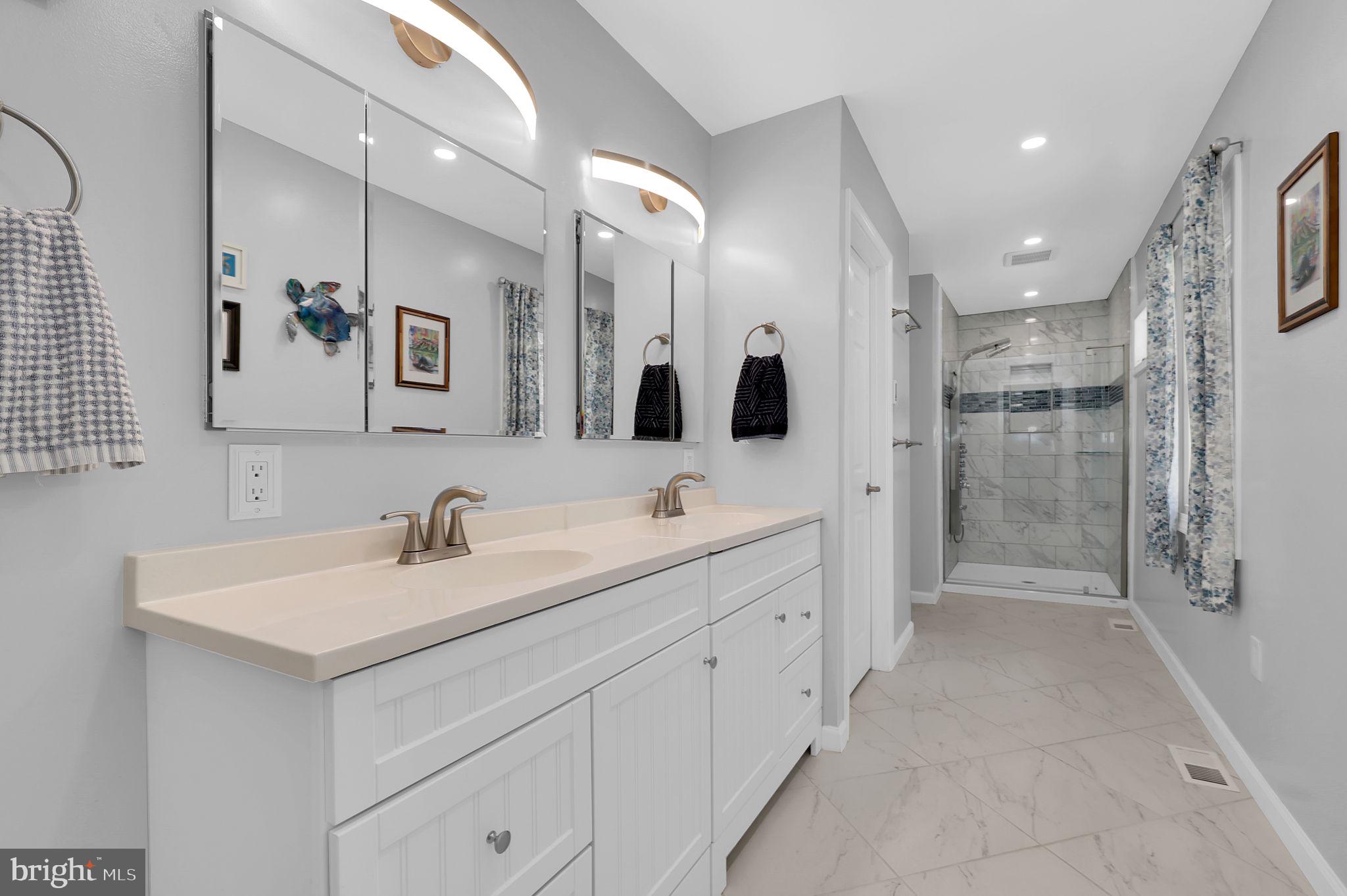 14336 Shirley Bohn Road Mount Airy, MD 21771 - Photo 26 of 56 a bathroom with a double vanity sink mirror and shower
