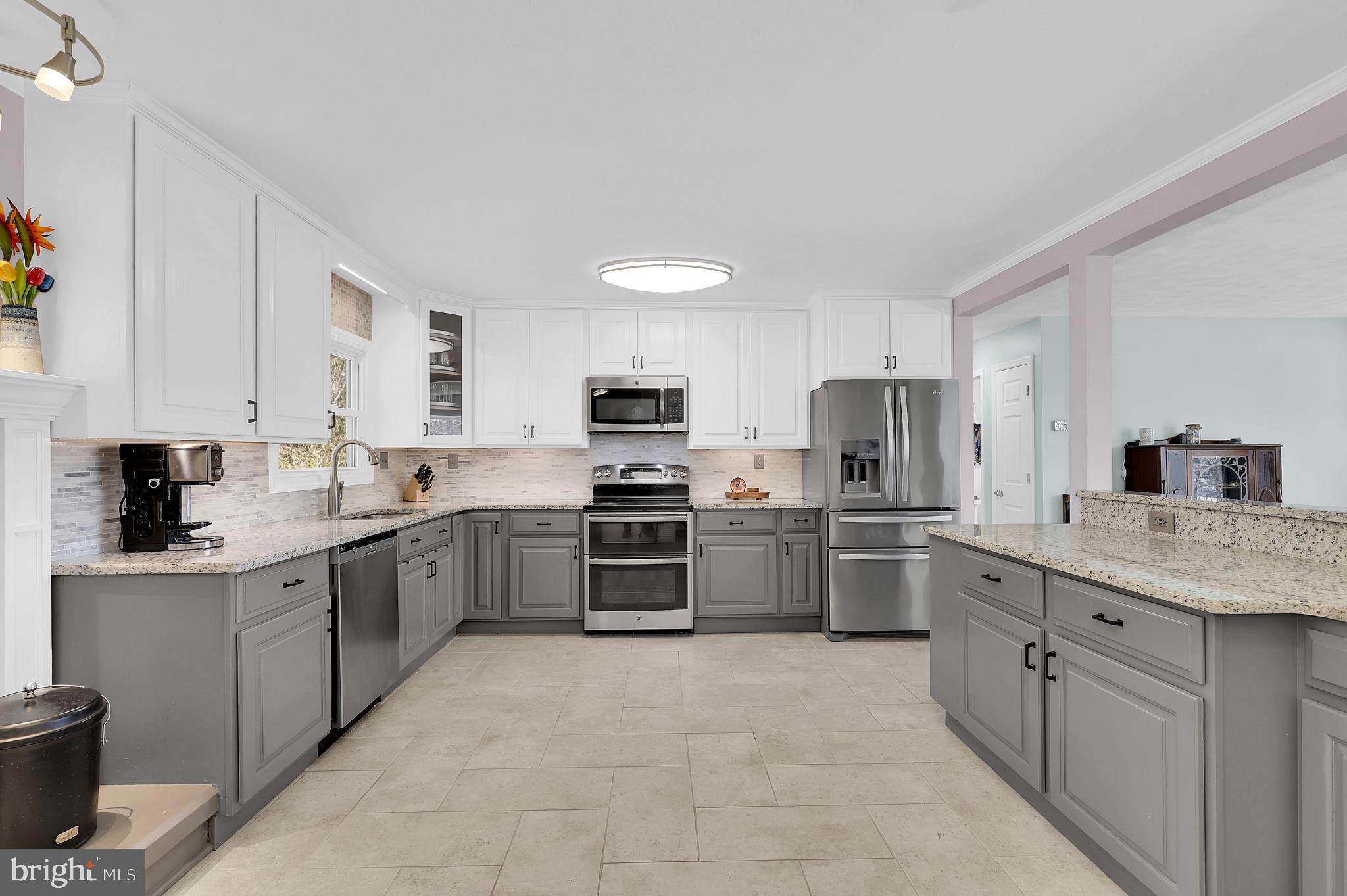 14336 Shirley Bohn Road Mount Airy, MD 21771 - Photo 5 of 56 a kitchen with stainless steel appliances granite countertop a sink counter space cabinets and a large window