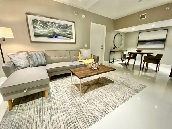 a living room with furniture and a rug