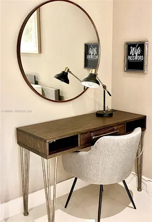 a view of a livingroom with furniture and a mirror