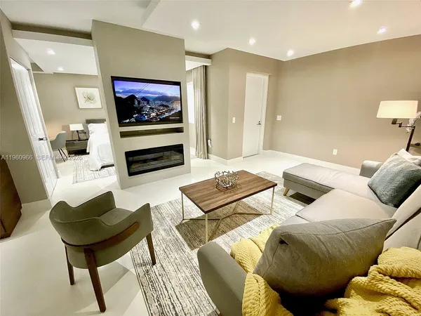 a bedroom with two beds and a television