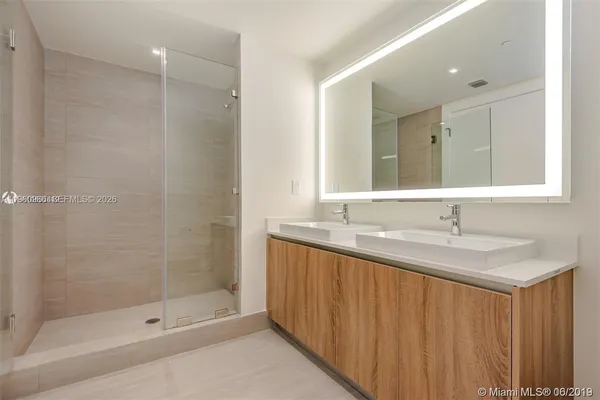 a bathroom with a shower and a sink