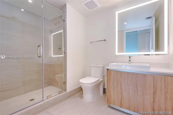 a bathroom with a toilet sink and a shower