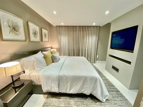 a bed sitting in a bedroom next to a window