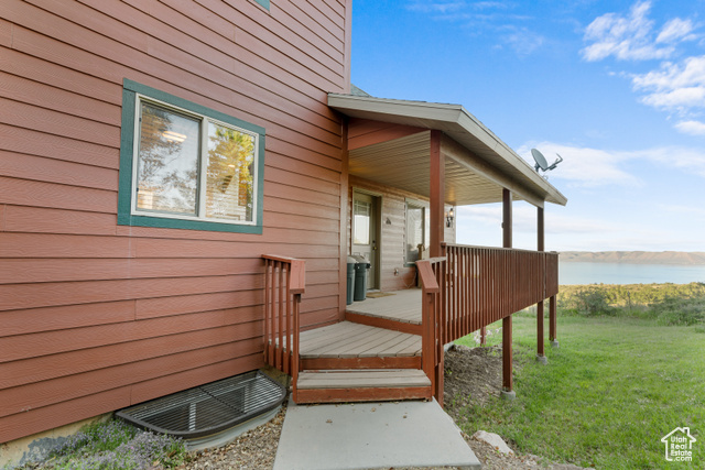 1340 Trapper Loop Garden City, UT 84028 - Photo 32 of 35 Deck with a water view and a lawn