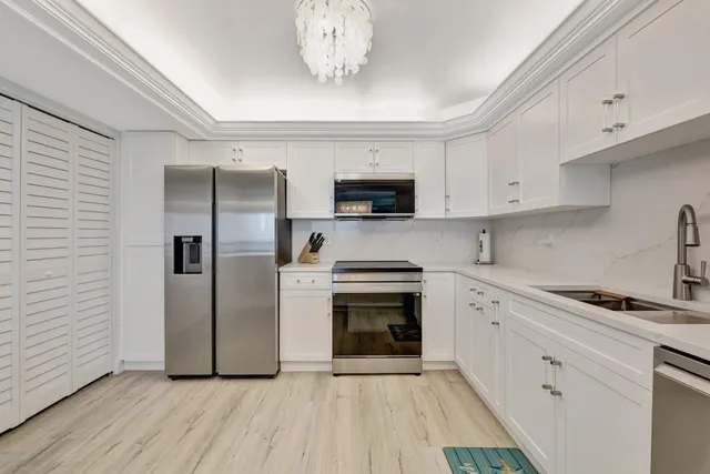 a kitchen with stainless steel appliances a refrigerator sink and microwave