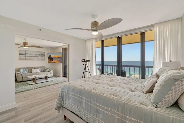 a bedroom with a bed and a large window with the outer view