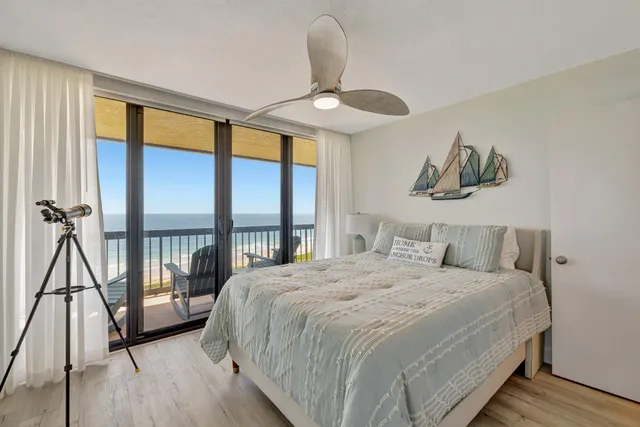 a bedroom with a bed and a large window