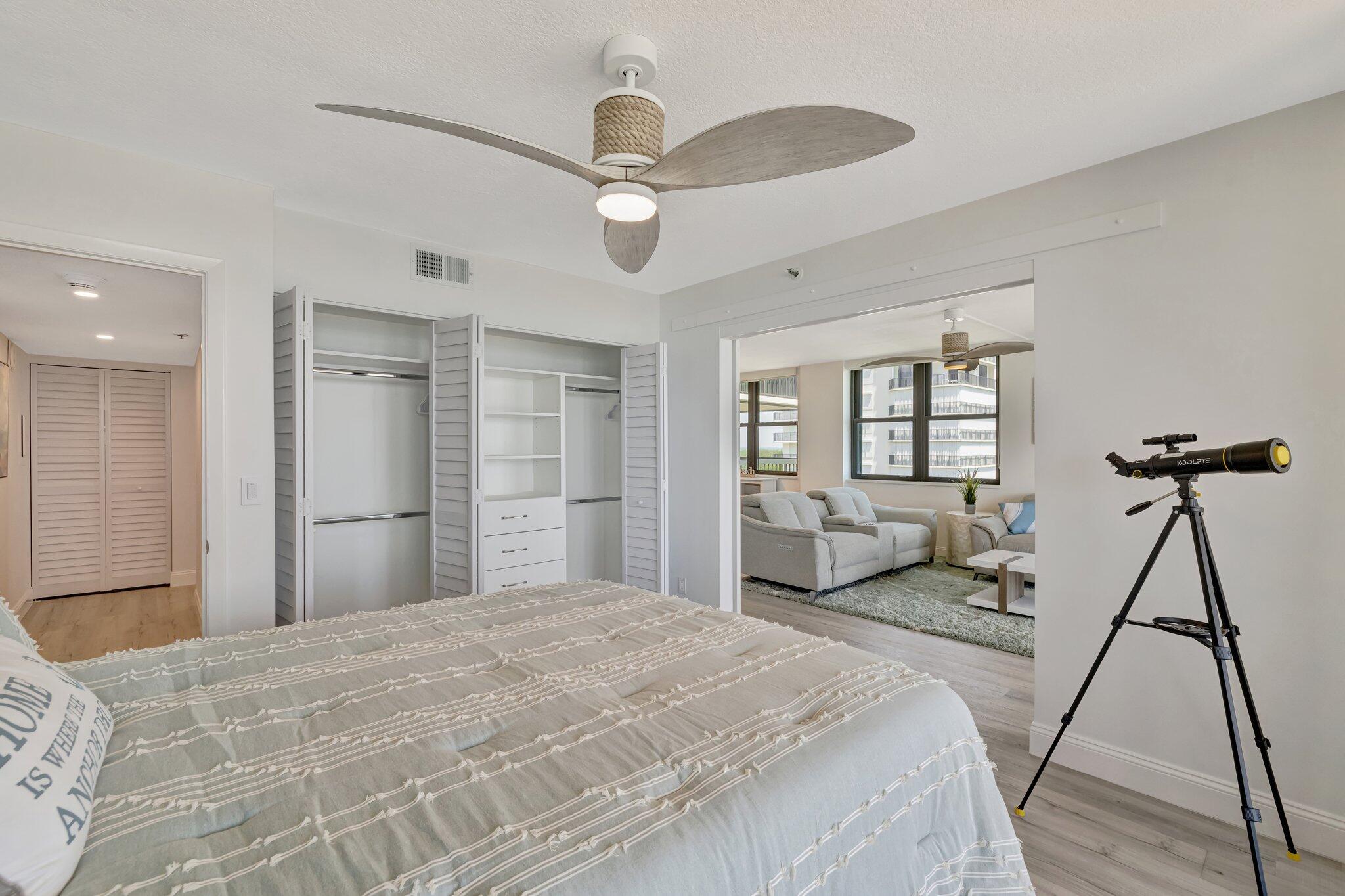 3100 North Hwy A1A, Unit 1102 Hutchinson Island, FL 34949 - Photo 16 of 55 a bedroom with a bed and a chandelier