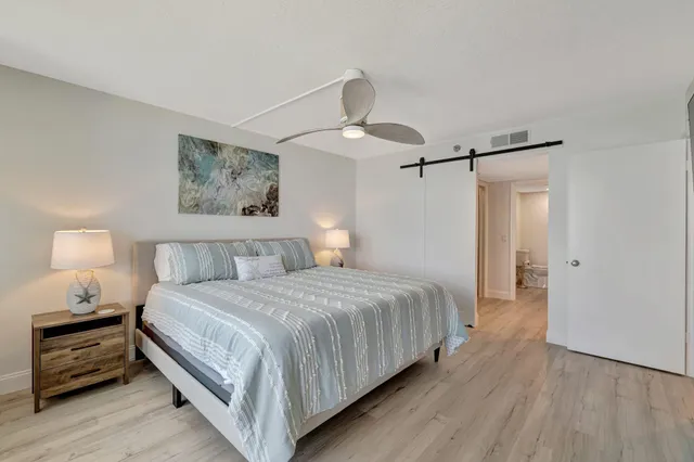 a bedroom with a bed and a lamp