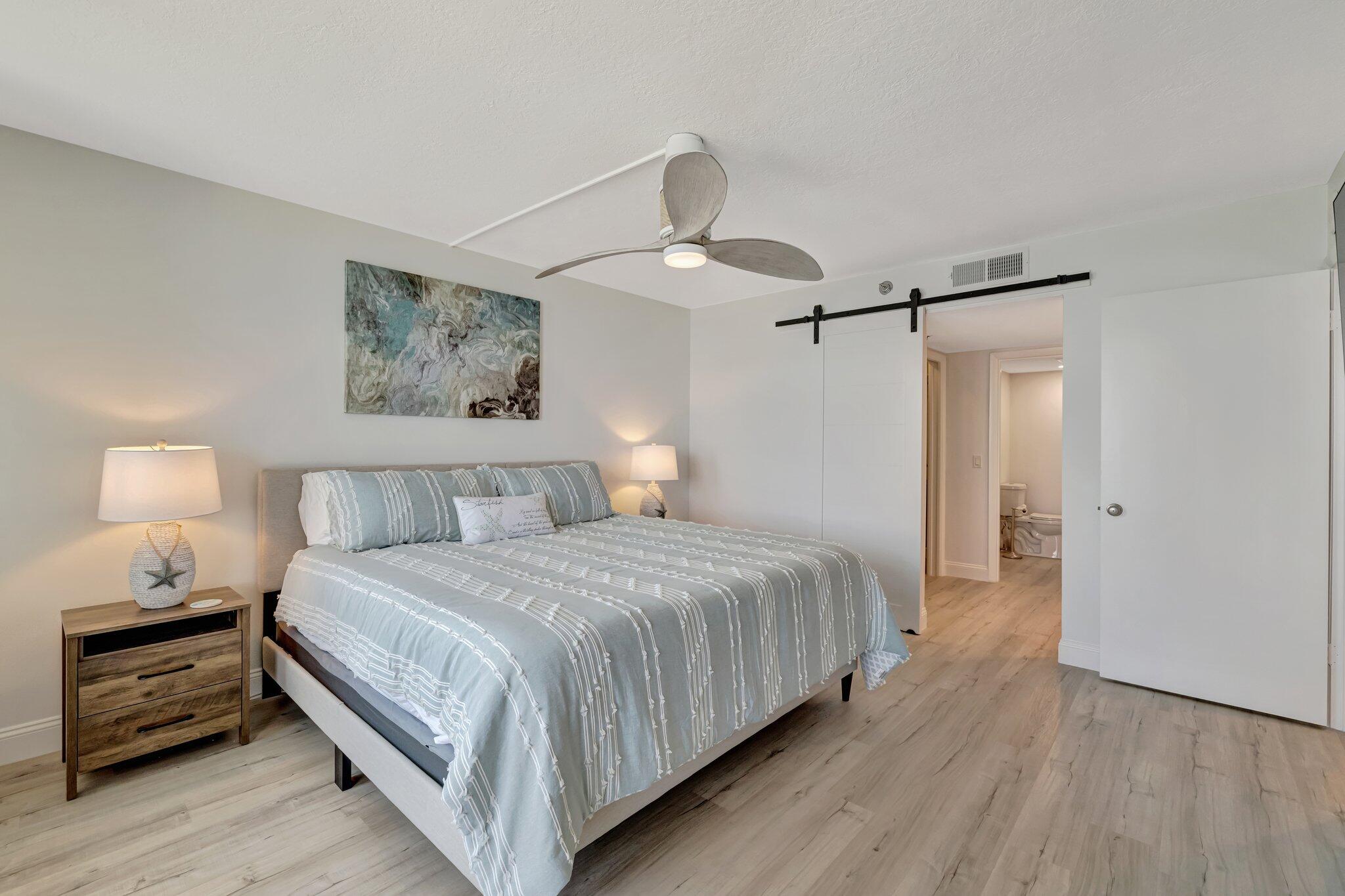 3100 North Hwy A1A, Unit 1102 Hutchinson Island, FL 34949 - Photo 20 of 55 a bedroom with a bed and a lamp