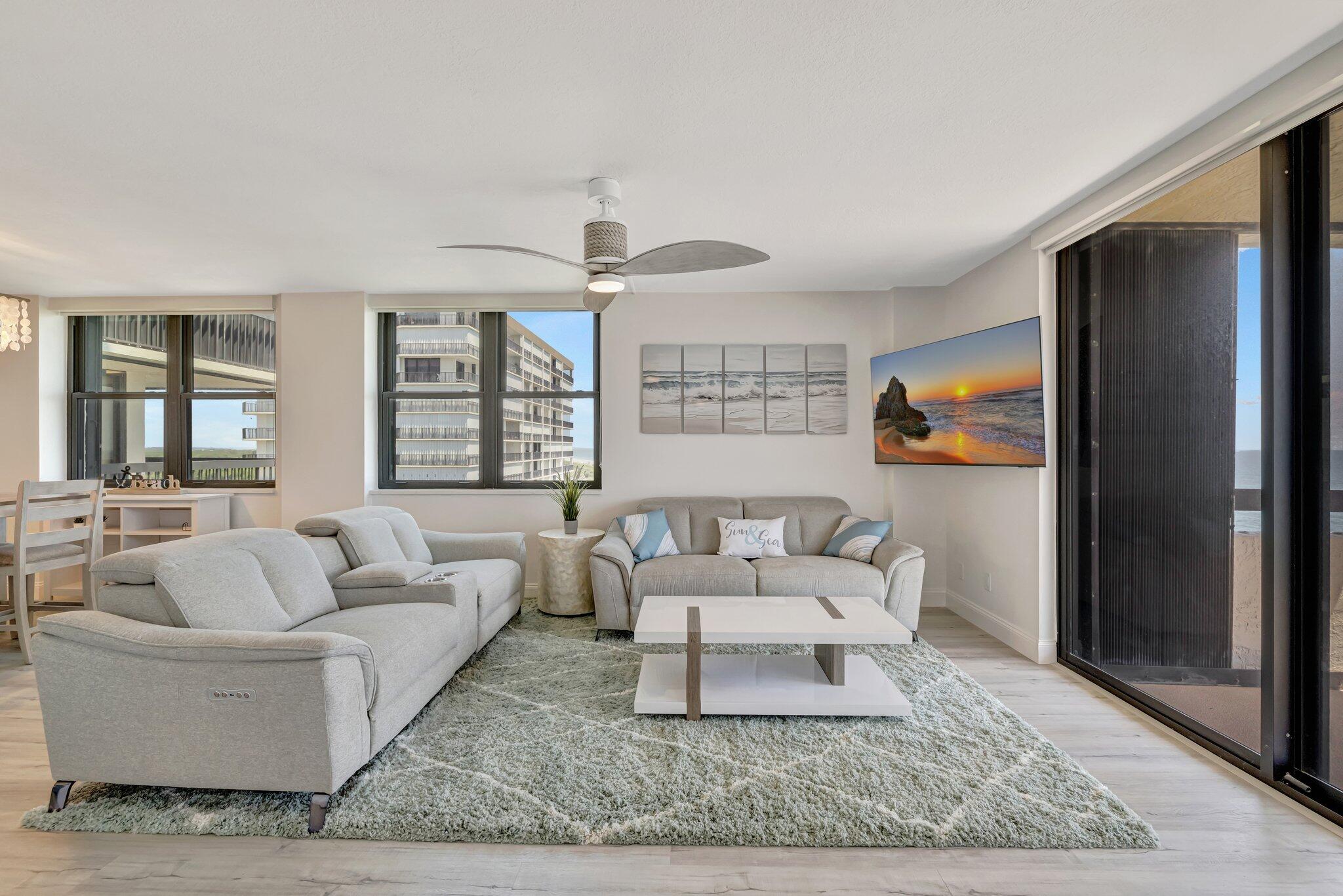 3100 North Hwy A1A, Unit 1102 Hutchinson Island, FL 34949 - Photo 2 of 55 a living room with furniture and a rug