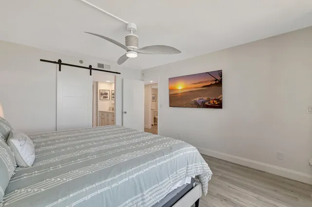 a bedroom with a bed and a painting on the wall