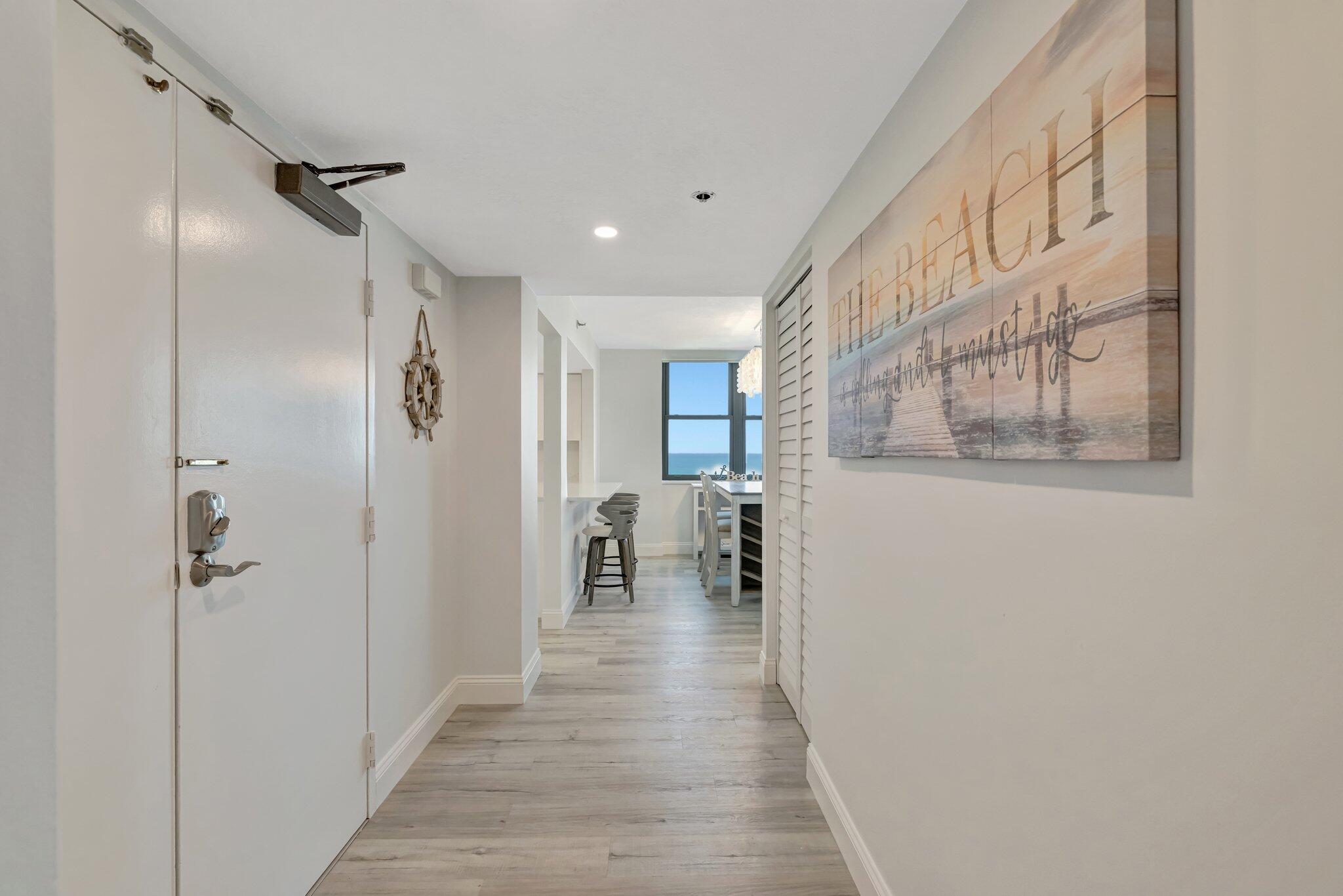 3100 North Hwy A1A, Unit 1102 Hutchinson Island, FL 34949 - Photo 26 of 55 a view of a hallway with wooden floor and staircase