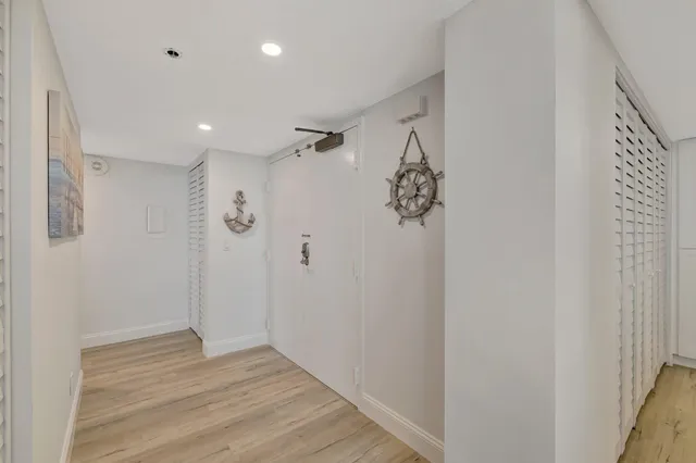 a view of a hallway with wooden floor