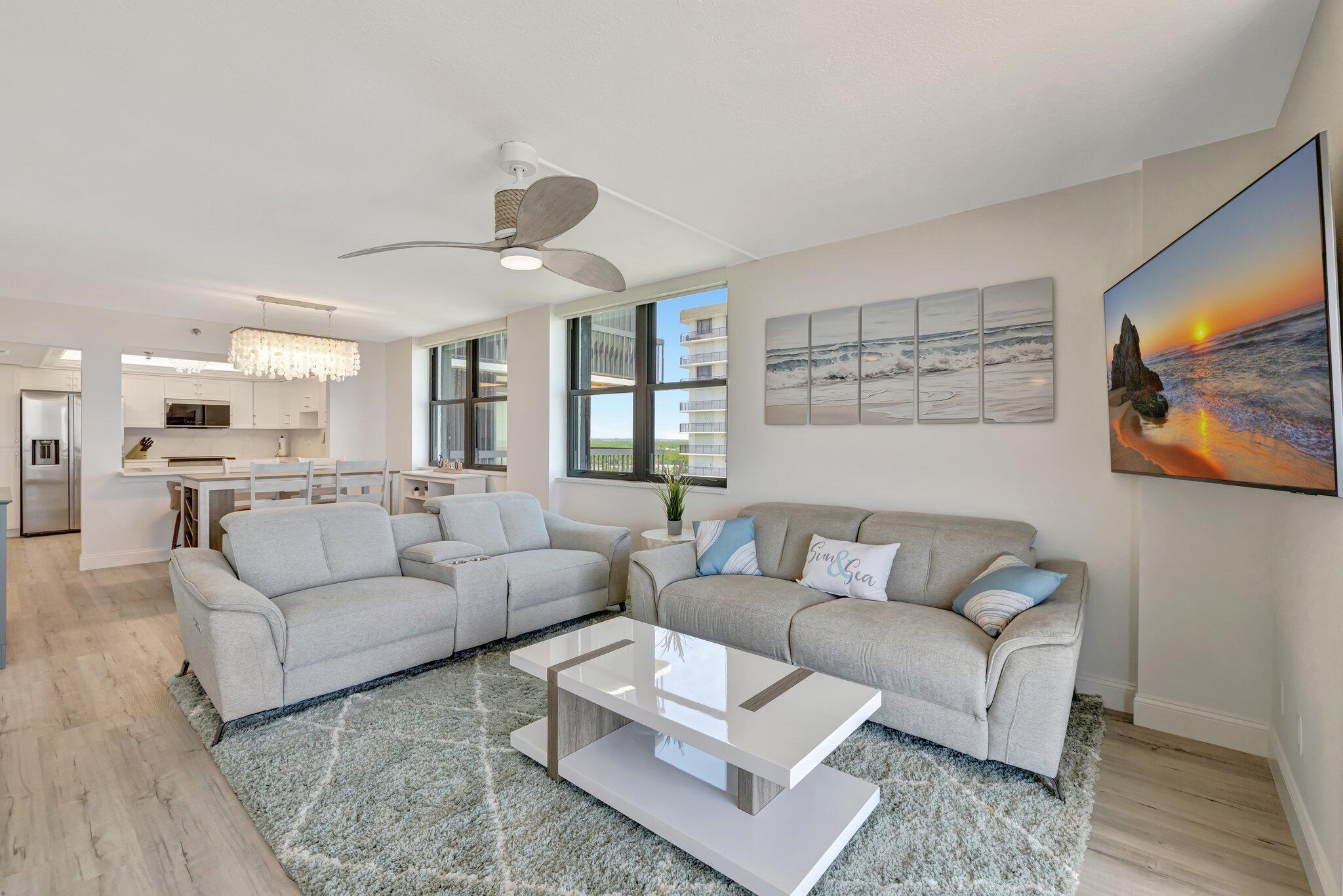 3100 North Hwy A1A, Unit 1102 Hutchinson Island, FL 34949 - Photo 3 of 55 a living room with furniture and kitchen view