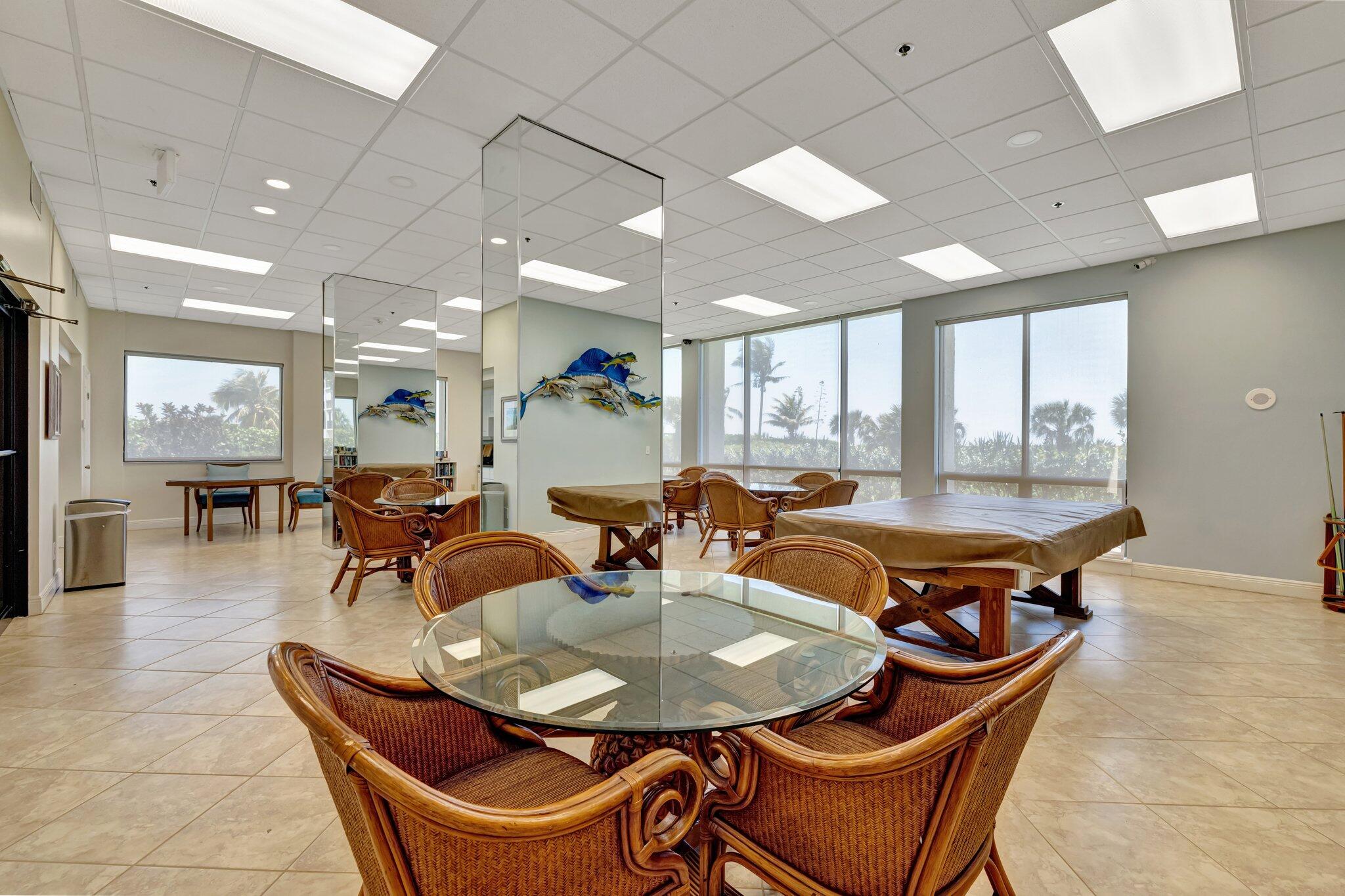 3100 North Hwy A1A, Unit 1102 Hutchinson Island, FL 34949 - Photo 54 of 55 a dining hall with stainless steel appliances a dining table and chairs with wooden floor
