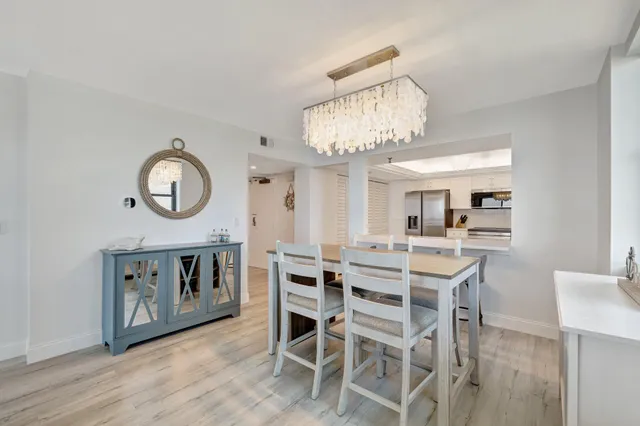 a view of a dining room with furniture and a chandelier