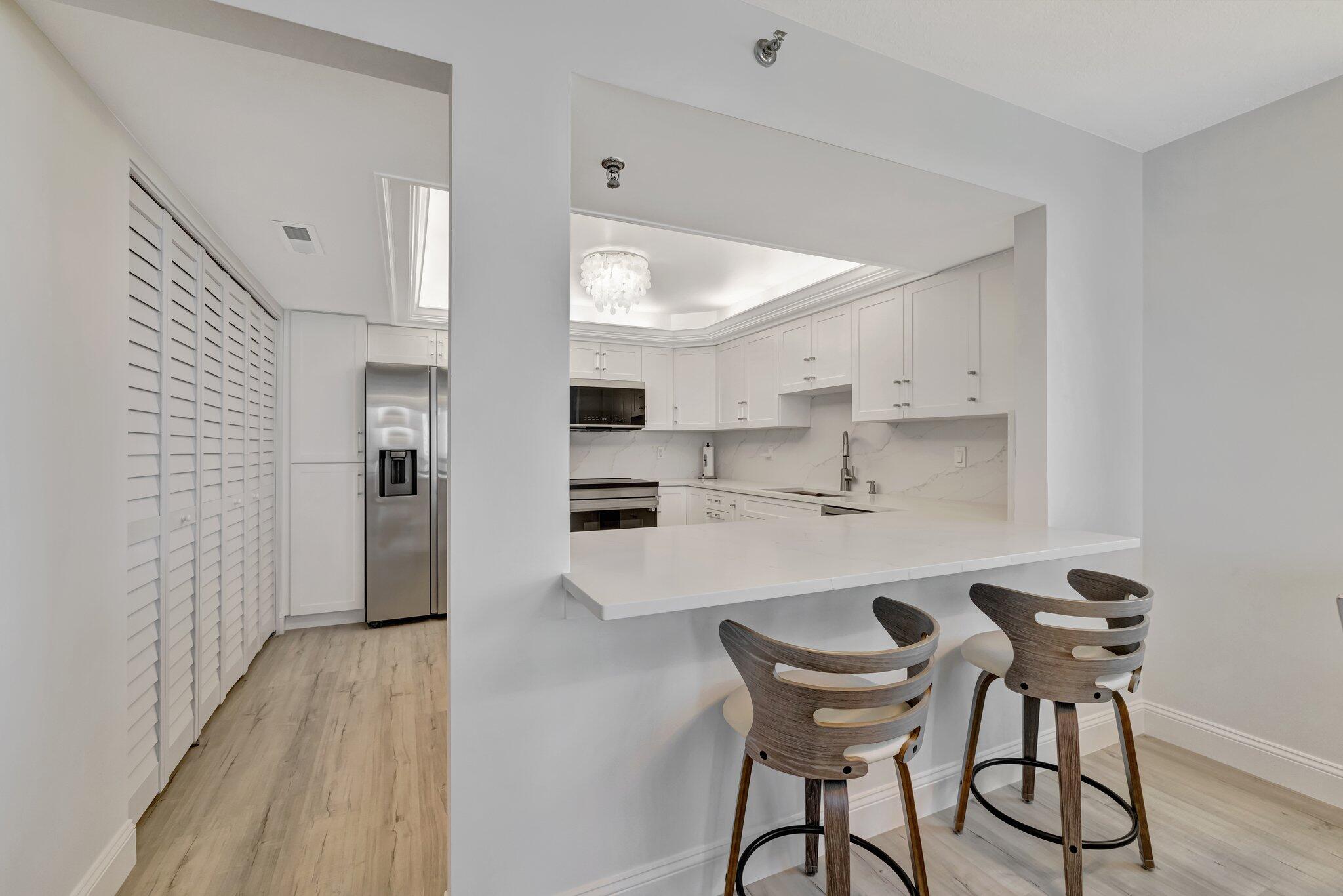 3100 North Hwy A1A, Unit 1102 Hutchinson Island, FL 34949 - Photo 7 of 55 a view of a dining room with furniture and wooden floor