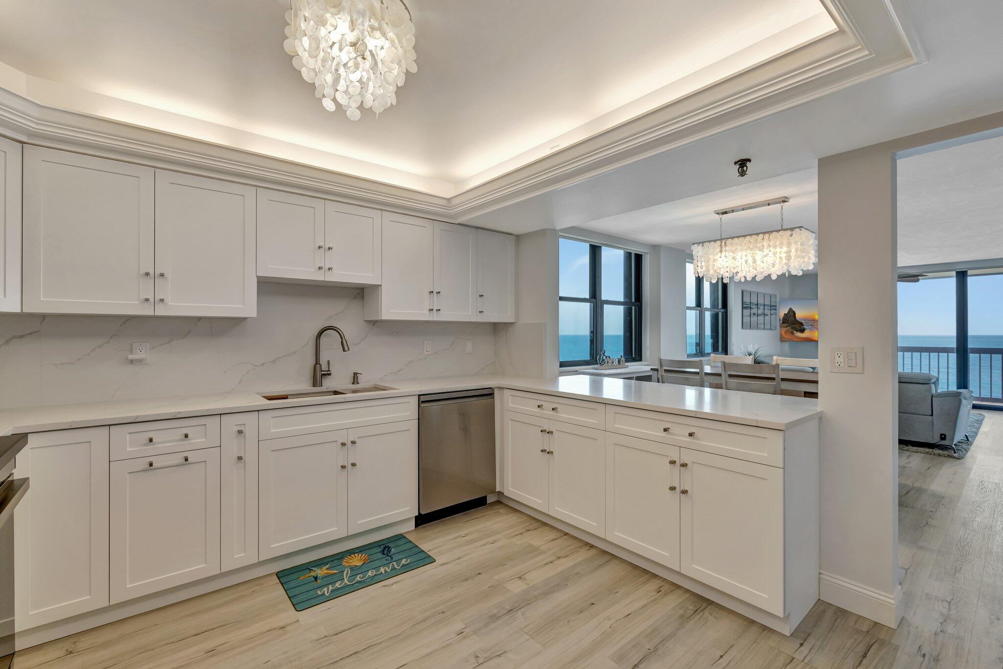 3100 North Hwy A1A, Unit 1102 Hutchinson Island, FL 34949 - Photo 8 of 55 a kitchen with a sink cabinets and window