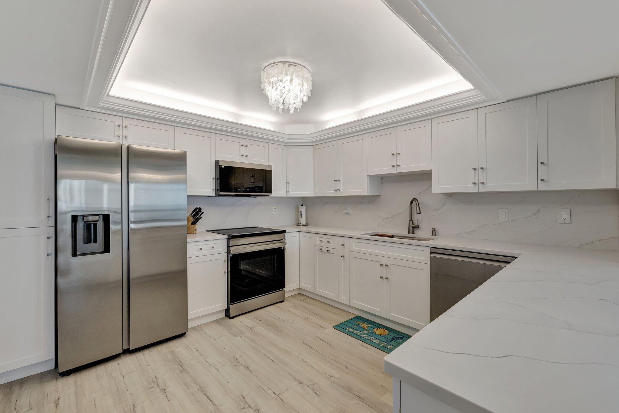 3100 North Hwy A1A, Unit 1102 Hutchinson Island, FL 34949 - Photo 9 of 55 a kitchen with a refrigerator stove and microwave