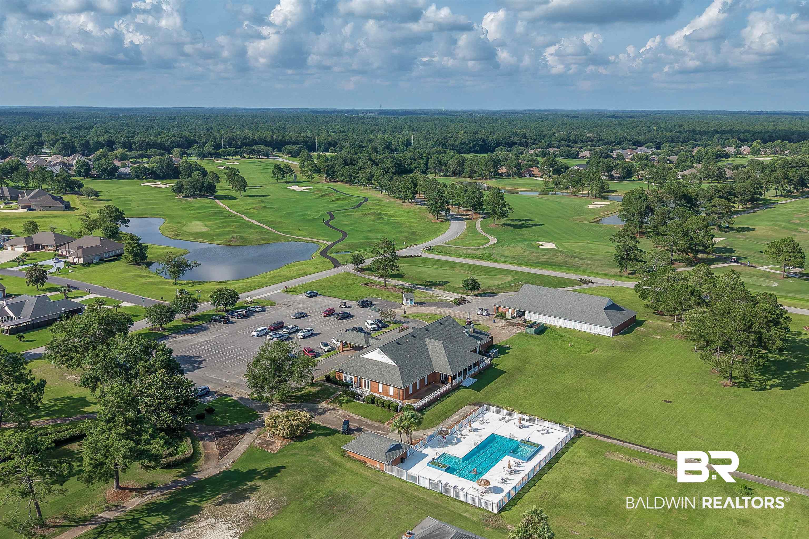 22685 County Road 12 Foley, AL 36535 - Photo 84 of 89 Aerial perspective highlighting a golf course community with a clubhouse, swimming pool, and substantial parking area