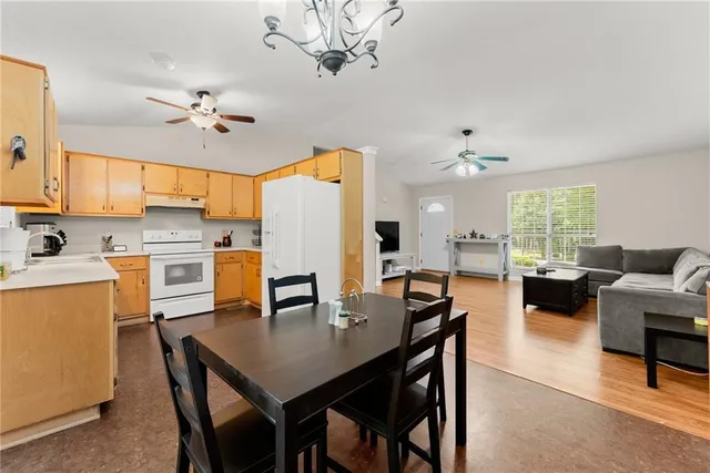 a kitchen with a table chairs and refrigerator