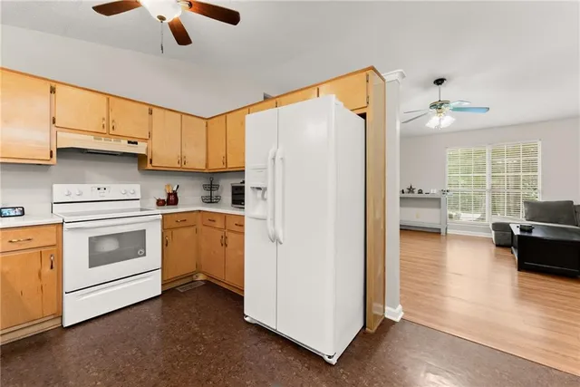 a kitchen with white cabinets and white appliances