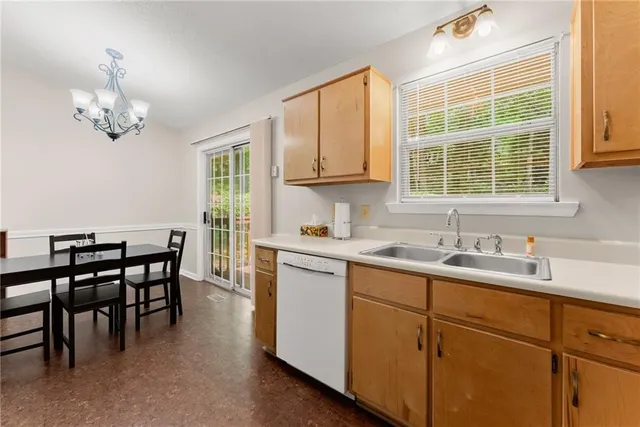a kitchen with a sink dining table and chairs