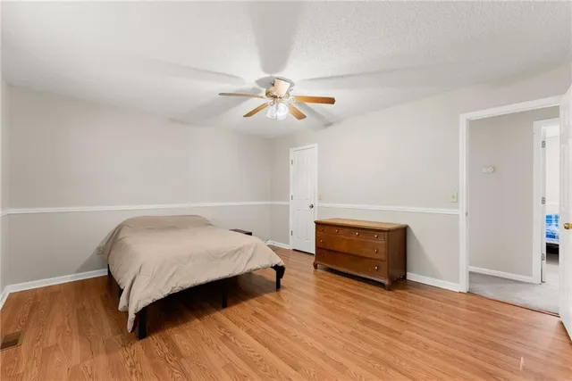 a bedroom with a bed and a ceiling fan