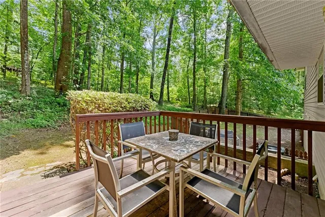 a view of a chairs and table on the wooden deck