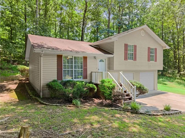 a view of a house with a yard and plants