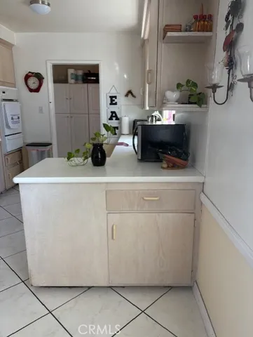 a room with cabinets and white appliances