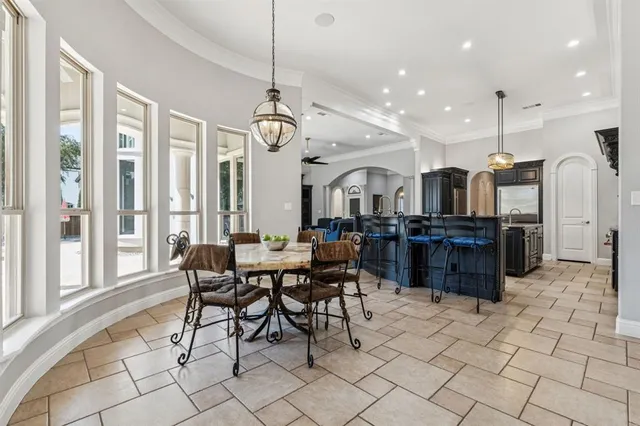 a large kitchen with a table and chairs
