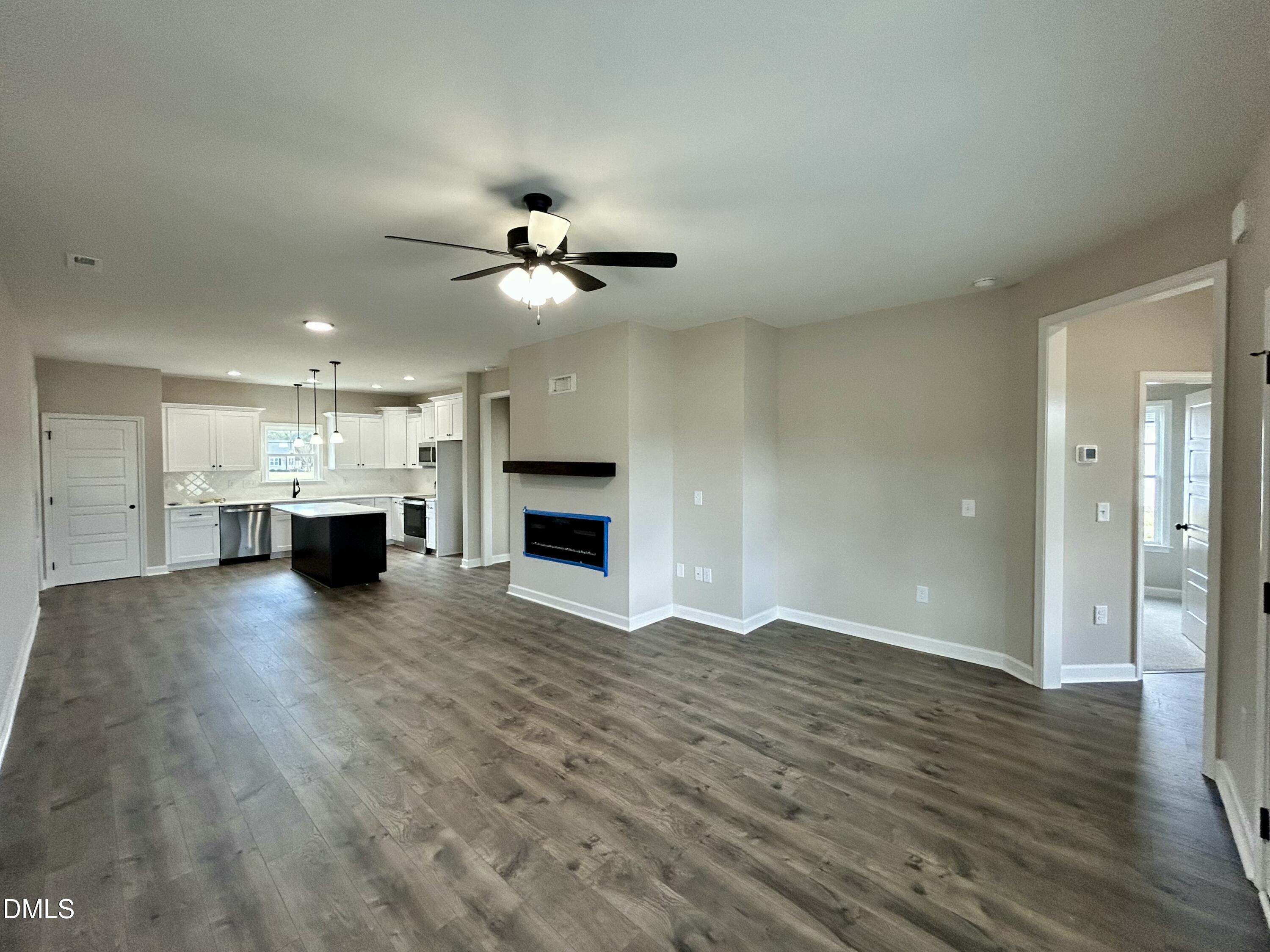 3684 Drew Farmer Road La Grange, NC 28551 - Photo 4 of 18 a view of empty room with a kitchen and a fireplace