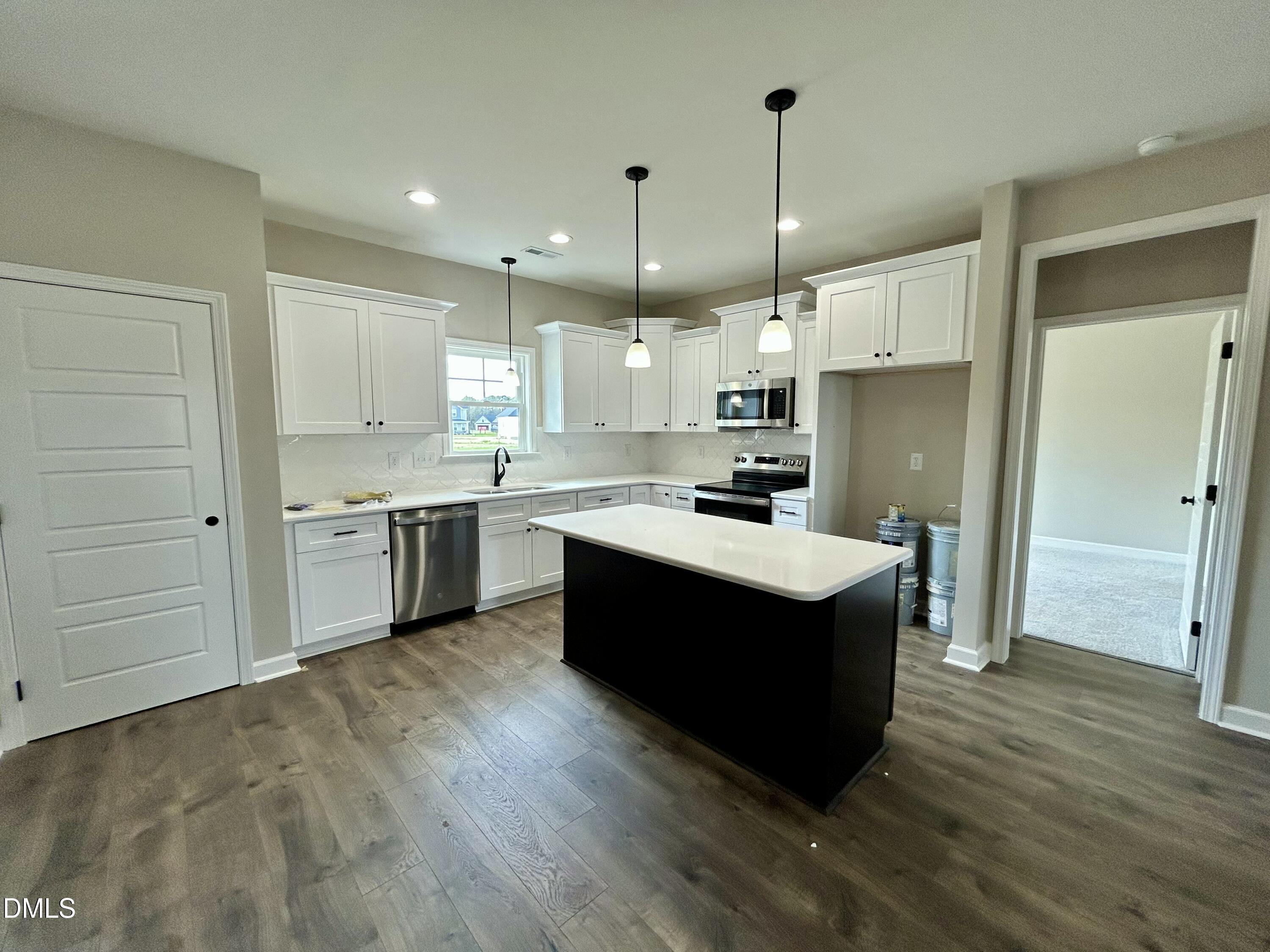 3684 Drew Farmer Road La Grange, NC 28551 - Photo 9 of 18 a kitchen with kitchen island wooden cabinets and white appliances