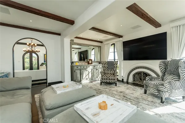 a living room with furniture a chandelier and a chandelier