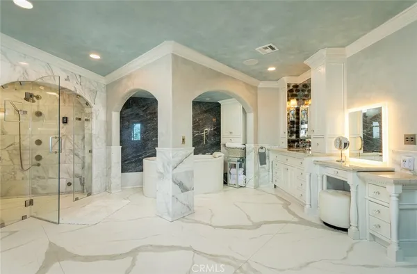 a bathroom with a granite countertop sink a toilet a mirror and shower