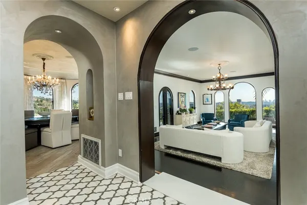 a living room with furniture and a large mirror
