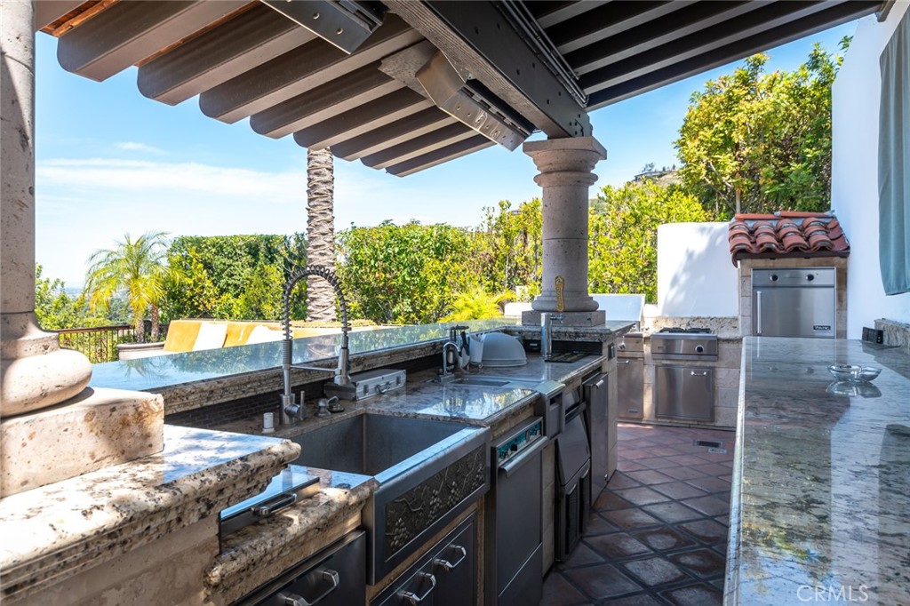 330 Kempton Road Glendale, CA 91202 - Photo 67 of 75 a kitchen with stainless steel appliances granite countertop a sink a stove and a wooden floor
