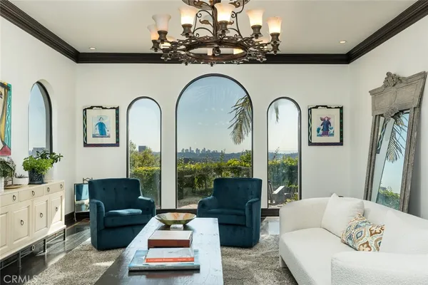a living room with furniture and a chandelier