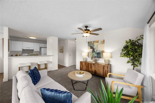 a living room with furniture and a chandelier