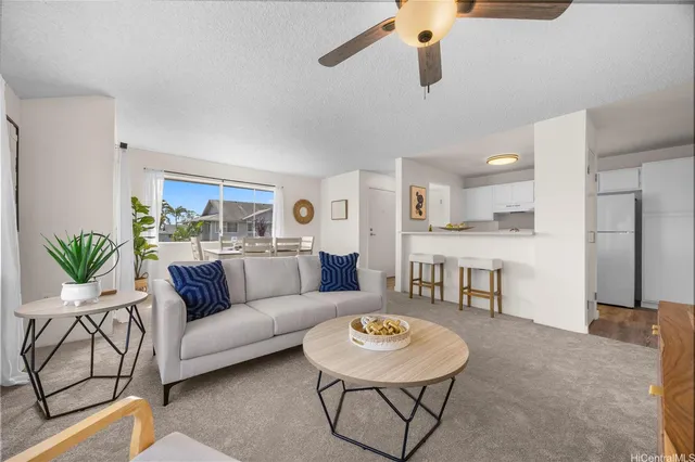 a living room with furniture and kitchen view