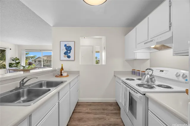 a kitchen that has a sink and a stove