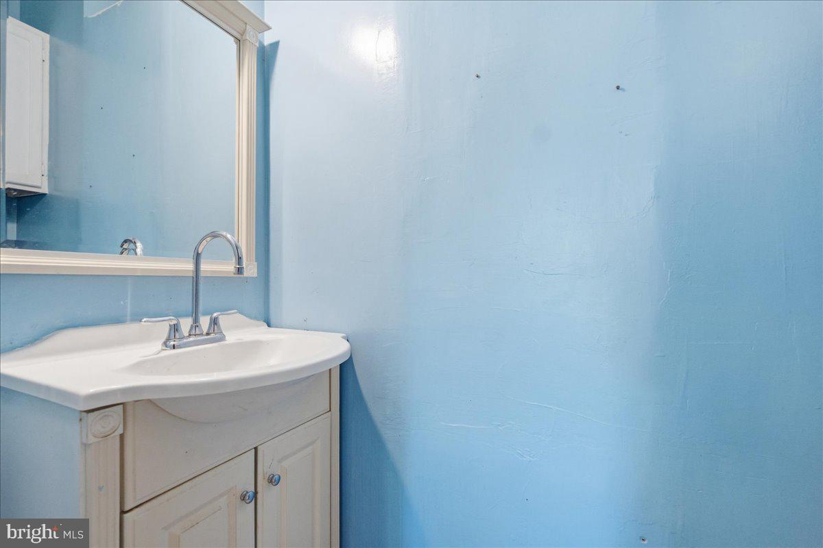 73 Church Road Arnold, MD 21012 - Photo 14 of 29 a bathroom with a sink a vanity and a mirror