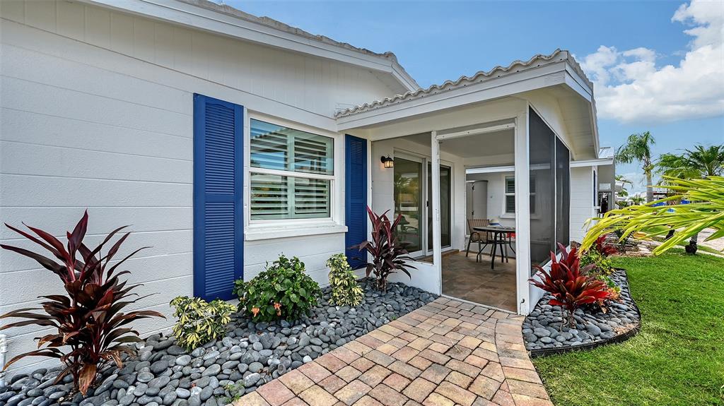 6020 Midnight Pass Road, Unit 63 Sarasota, FL 34242 - Photo 18 of 52 a front view of a house with a garden